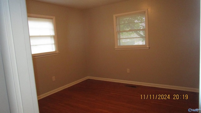 unfurnished room featuring dark wood-type flooring