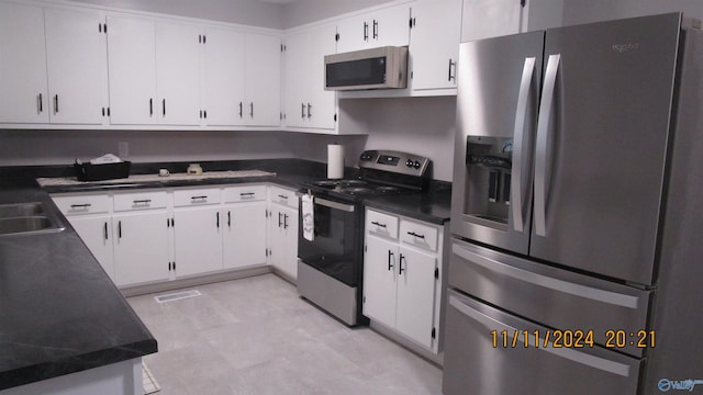 kitchen featuring sink, white cabinetry, and stainless steel appliances