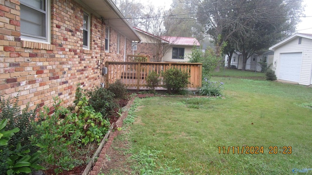 view of yard featuring a garage and a wooden deck