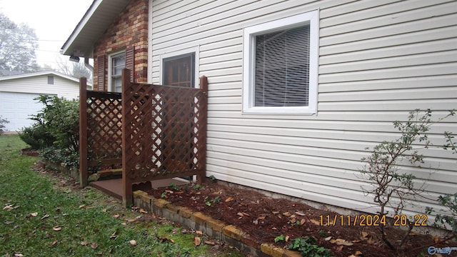 view of side of home featuring an outbuilding and a garage