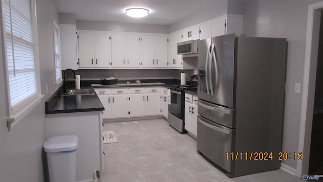 kitchen featuring sink, white cabinets, and stainless steel appliances