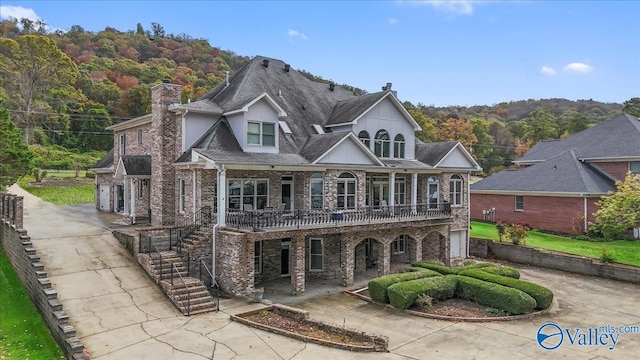 view of front of house featuring a balcony and a garage