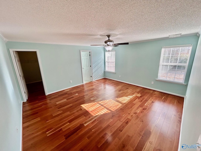 empty room with hardwood / wood-style floors, a textured ceiling, and ceiling fan