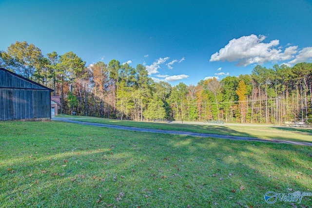 view of yard with a forest view