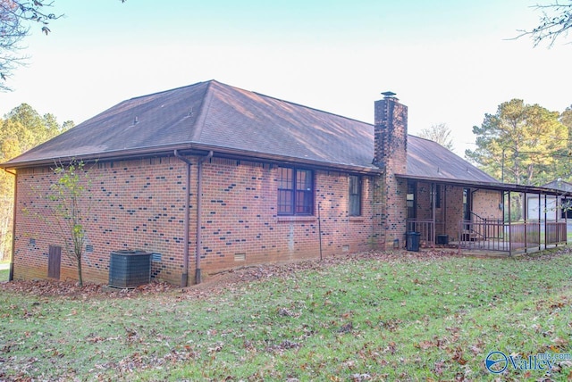 view of property exterior with central AC unit, brick siding, a yard, crawl space, and a chimney