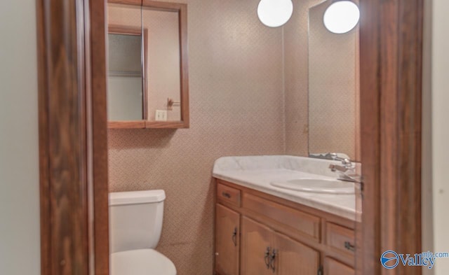 bathroom featuring vanity and toilet