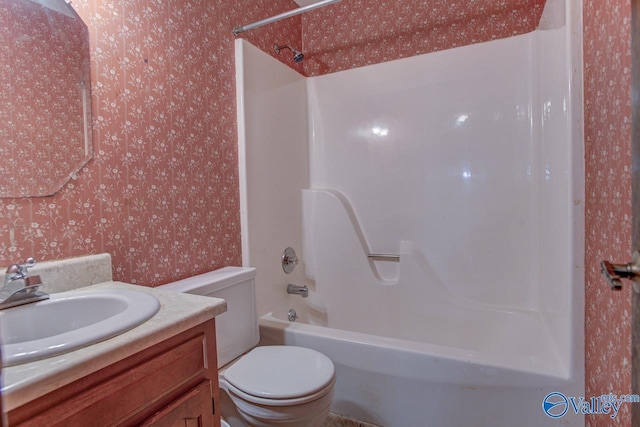 full bath featuring toilet, wallpapered walls, tub / shower combination, and vanity