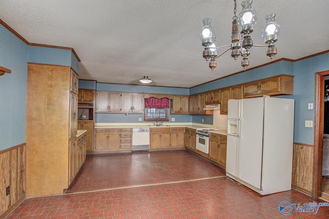 kitchen featuring brick floor, white appliances, light countertops, and under cabinet range hood