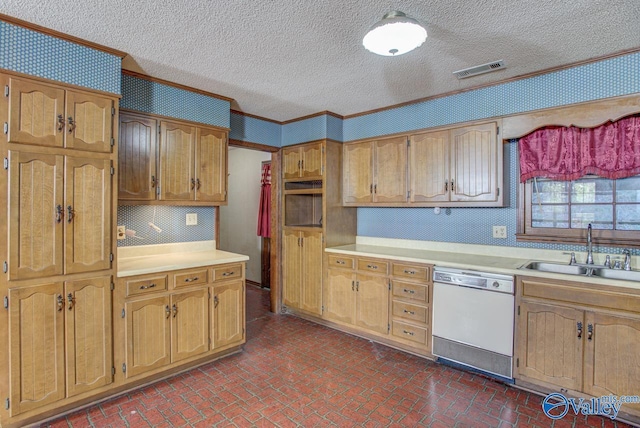 kitchen featuring visible vents, dishwasher, brick floor, light countertops, and a sink