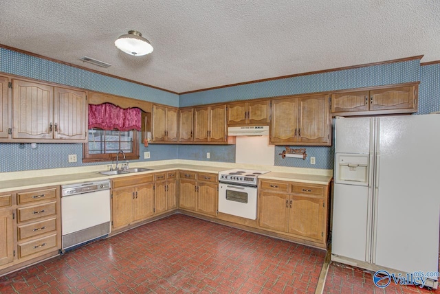 kitchen featuring white appliances, under cabinet range hood, light countertops, and a sink