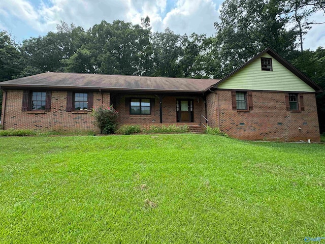 ranch-style home featuring brick siding and a front lawn