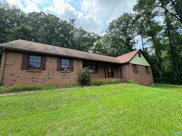 ranch-style home with brick siding and a front yard