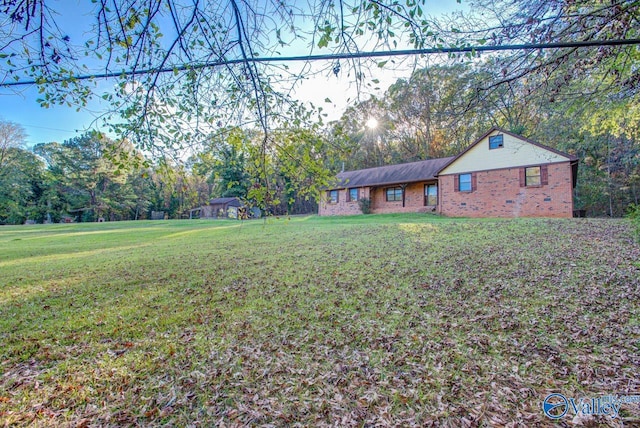 single story home with a front yard and brick siding