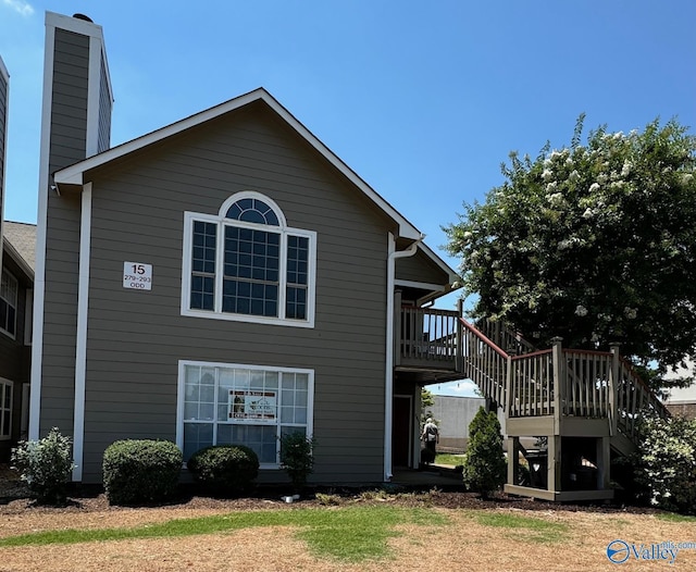 view of side of home with a wooden deck