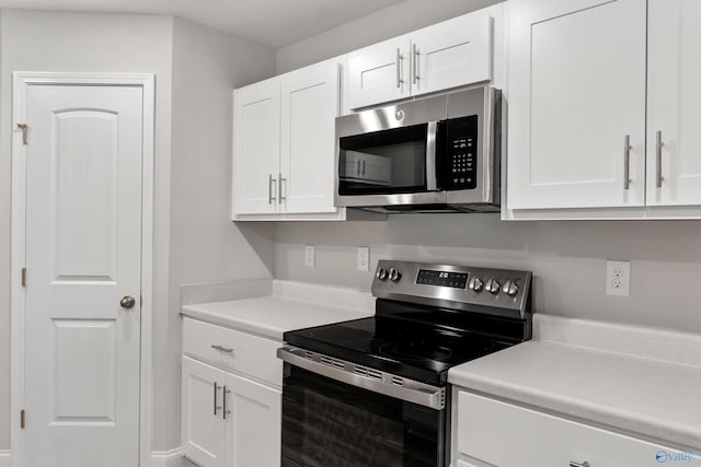 kitchen with appliances with stainless steel finishes and white cabinetry