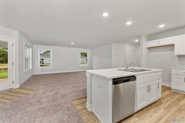 kitchen featuring plenty of natural light, dishwasher, white cabinetry, and sink