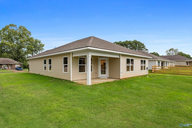 rear view of property with a patio and a yard