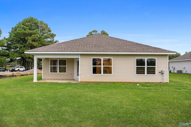 back of house featuring central AC, a patio area, and a yard