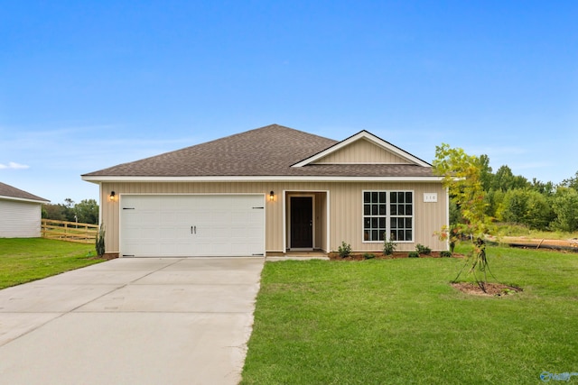 ranch-style home featuring a garage and a front lawn