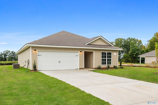 view of front of house with a garage, central air condition unit, and a front lawn