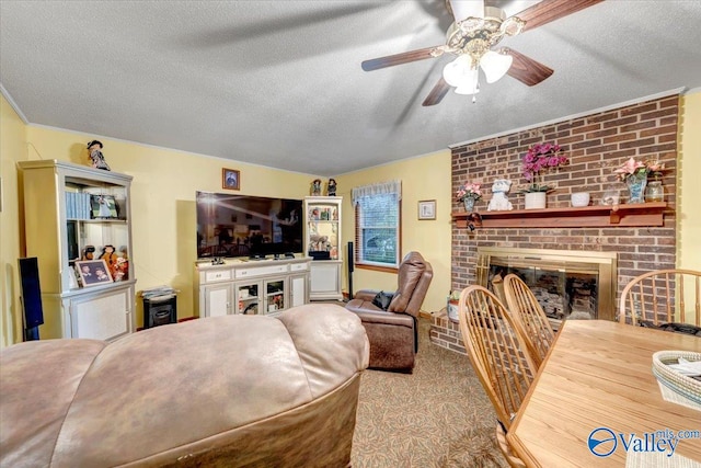 living room featuring a brick fireplace, ceiling fan, a textured ceiling, and light carpet