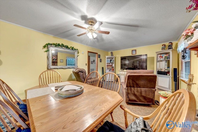 dining room with a textured ceiling and ceiling fan