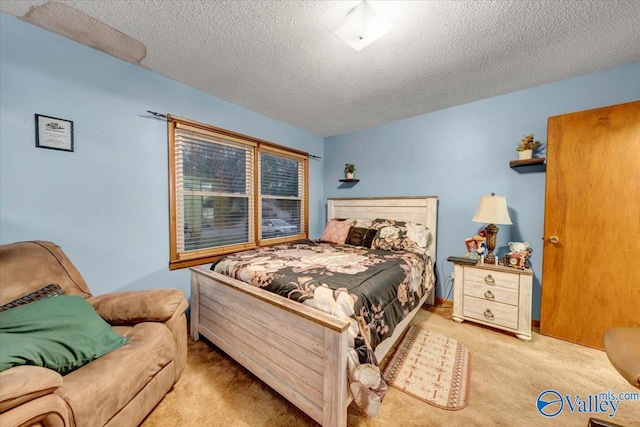 carpeted bedroom featuring a textured ceiling