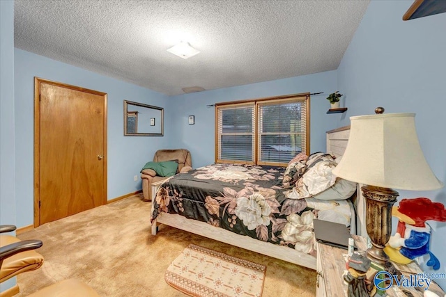 bedroom featuring carpet and a textured ceiling