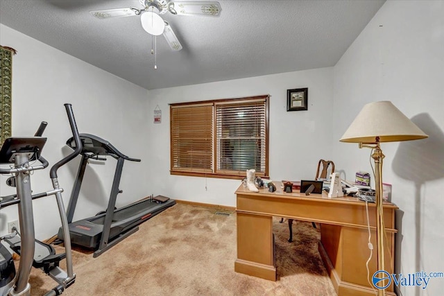 home office featuring ceiling fan, a textured ceiling, and carpet floors