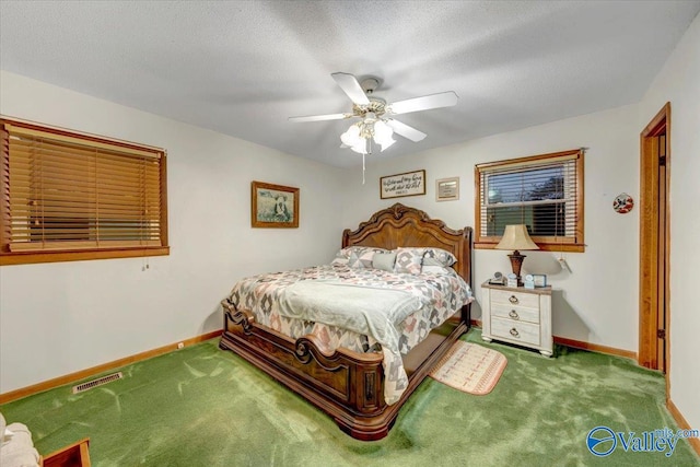 carpeted bedroom with a textured ceiling and ceiling fan