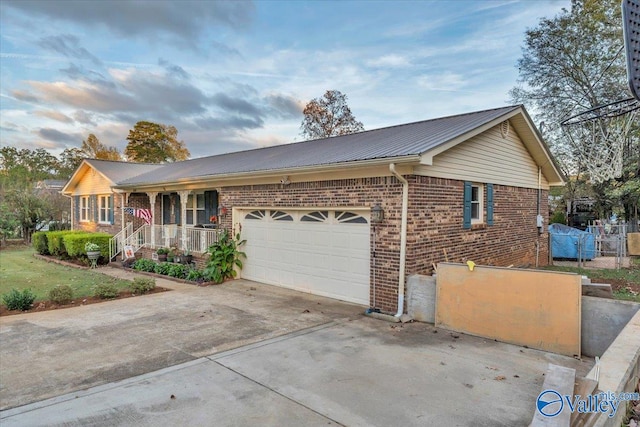 single story home with a garage and a porch