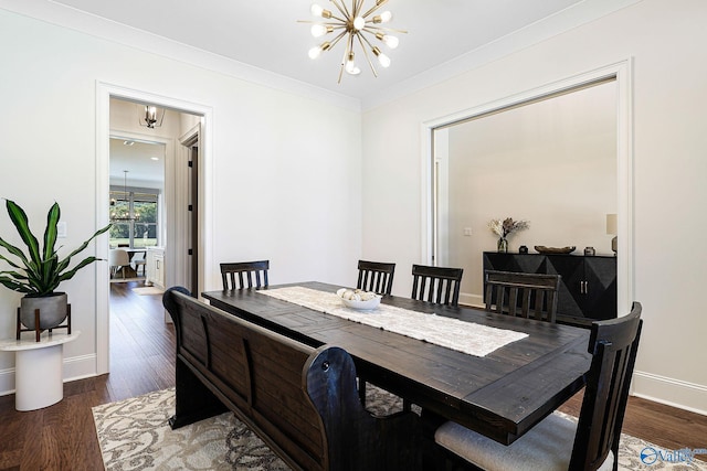 dining space featuring baseboards, an inviting chandelier, ornamental molding, and wood finished floors