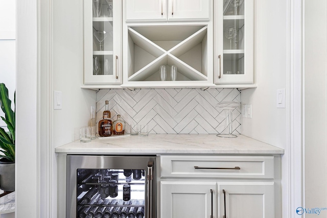 bar with a bar, wine cooler, and backsplash