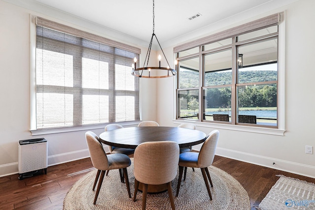 dining space with baseboards, a wealth of natural light, dark wood-style flooring, and a chandelier