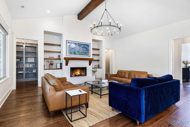 living area with built in shelves, plenty of natural light, beamed ceiling, and wood finished floors