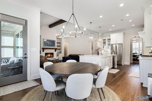 dining area featuring recessed lighting, baseboards, dark wood-style floors, and a notable chandelier