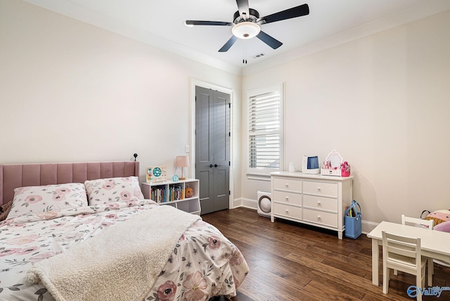 bedroom featuring baseboards, ceiling fan, wood finished floors, and visible vents