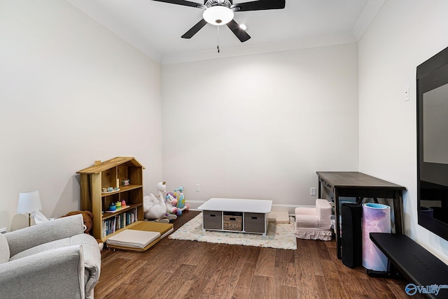 interior space featuring ornamental molding, a ceiling fan, and dark wood finished floors