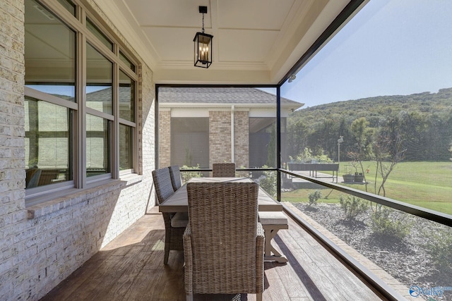 sunroom with a mountain view and a wealth of natural light
