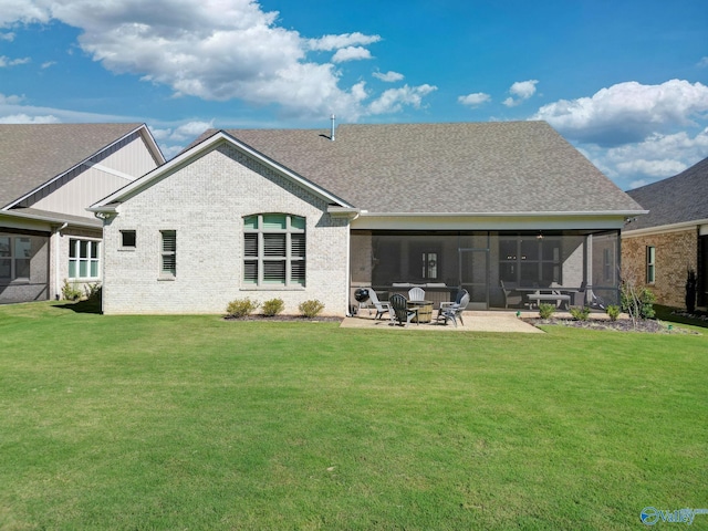 rear view of house featuring a sunroom, a yard, and a patio area