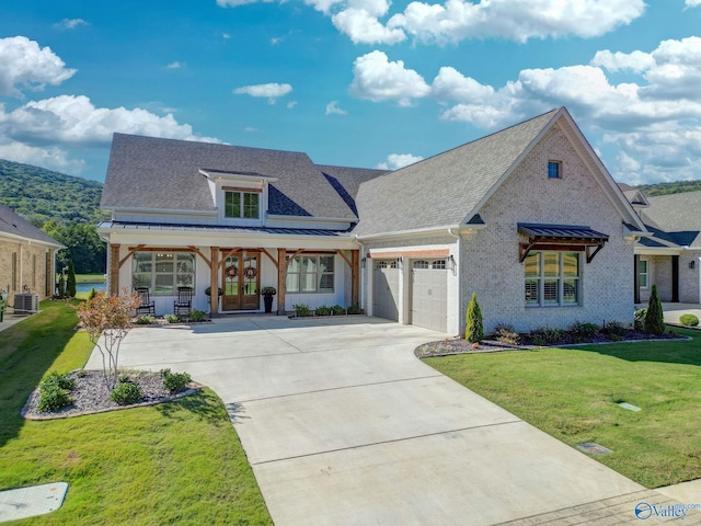 view of front of home featuring a garage, a front lawn, french doors, a shingled roof, and driveway