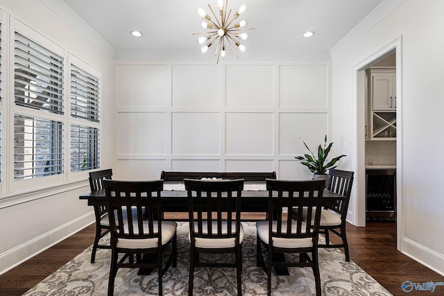 dining area with crown molding, an inviting chandelier, dark wood-type flooring, and a decorative wall