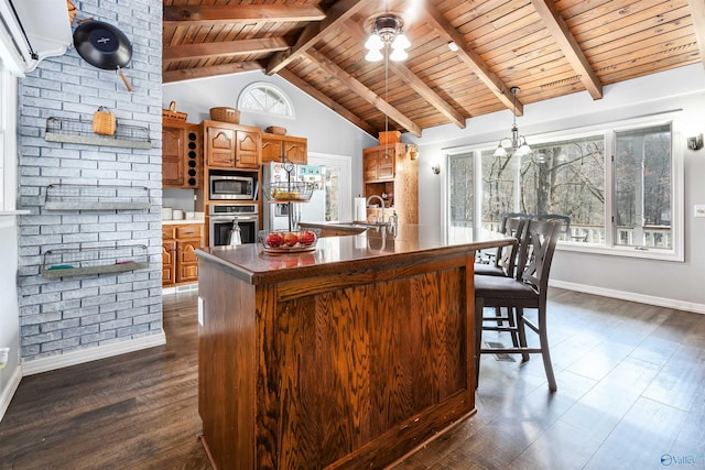 kitchen featuring a center island with sink, open shelves, stainless steel appliances, dark countertops, and brown cabinetry