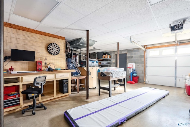 interior space with a garage door opener and concrete block wall