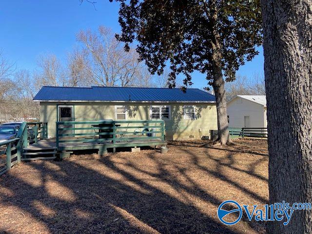 rear view of property with a wooden deck