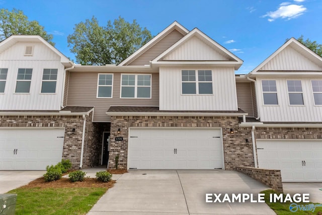 view of property featuring brick siding, driveway, and an attached garage