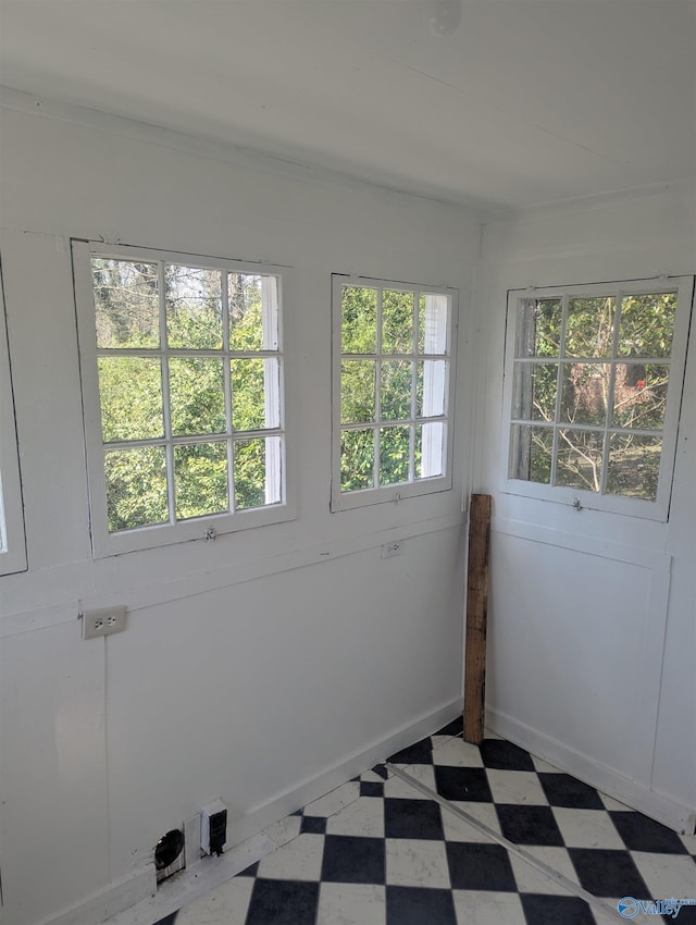 spare room with tile patterned floors and baseboards