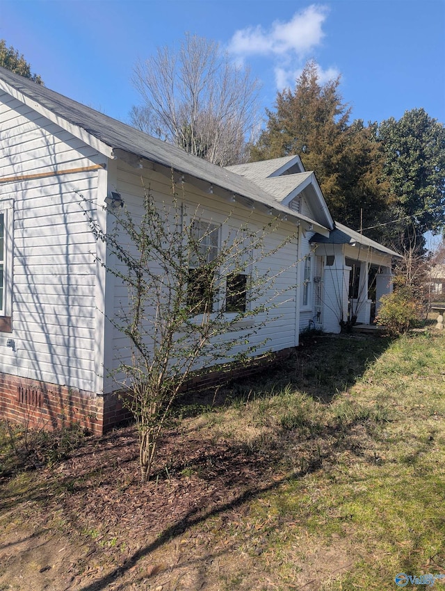 view of property exterior with a lawn