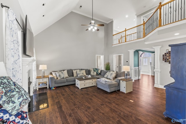 living room featuring ceiling fan, dark hardwood / wood-style flooring, a high ceiling, and ornate columns