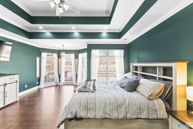 bedroom with dark hardwood / wood-style flooring, crown molding, and a raised ceiling